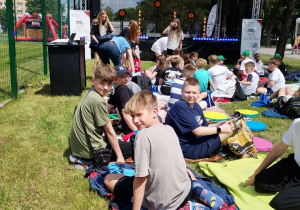 Uczniowie klasy 6a odpoczywają w strefie uczestników podczas finału projektu „Sport Kocha Recykling” w Warszawie.
